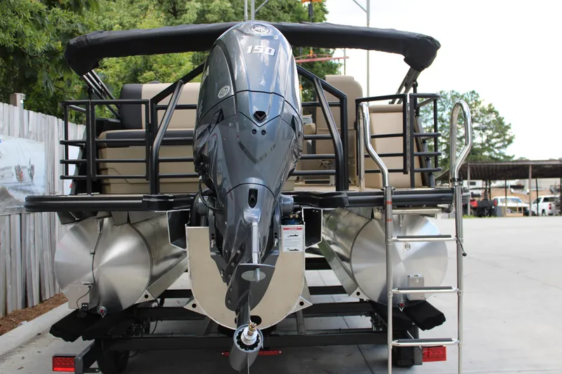 Slide: The Image of 2026 Starcraft EXS 1 Q DH pontoon boat with powerful outboard motor, parked on trailer. - 7
