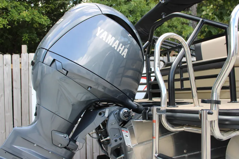 Slide: The Image of Yamaha outboard motor on 2026 Starcraft EXS 1 Q DH boat, docked with metal ladder. - 8