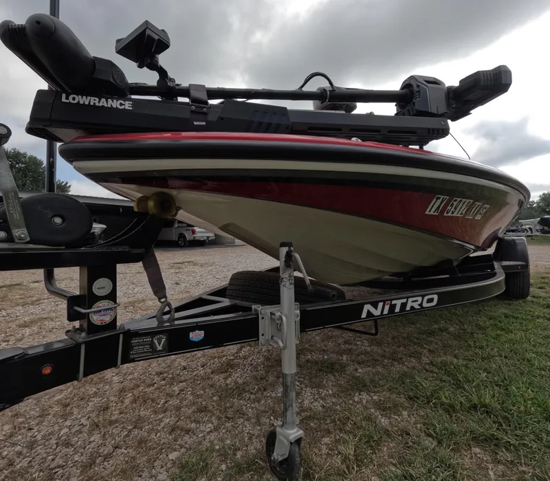 Slide: The Image of 2016 Nitro Z20 boat on trailer, featuring Lowrance equipment, parked on gravel. - 13