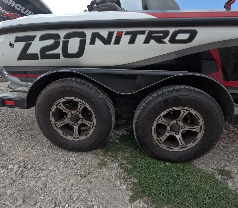 Slide: The Image of 2016 Nitro Z20 boat trailer with dual wheels on gravel surface. - 15