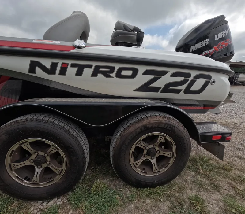 Slide: The Image of 2016 Nitro Z20 boat on trailer with Mercury Pro XS engine, parked on grass. - 16