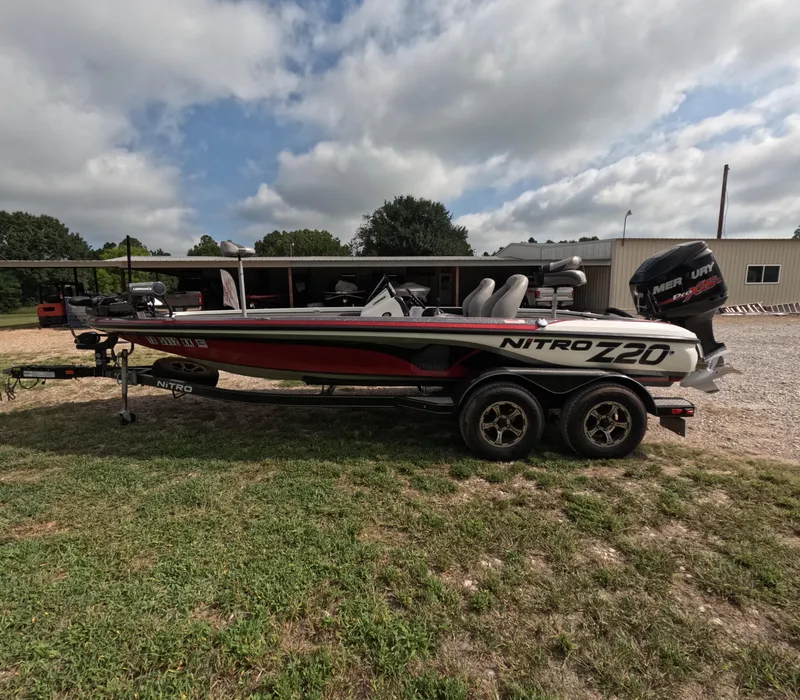 Slide: The Image of 2016 Nitro Z20 boat on trailer, parked outdoors under cloudy sky. - 3