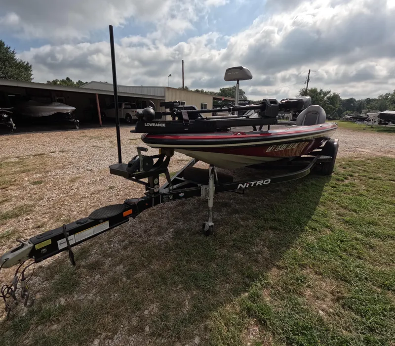 Slide: The Image of 2016 Nitro Z20 boat on trailer, parked outdoors under cloudy sky. - 4