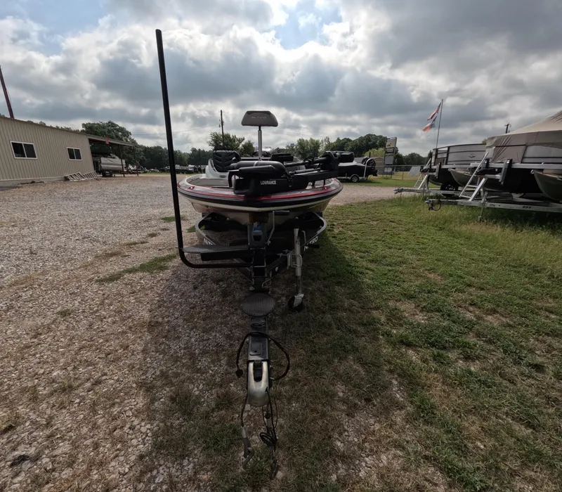 Slide: The Image of 2016 Nitro Z20 boat on trailer, parked on gravel and grass under cloudy sky. - 5