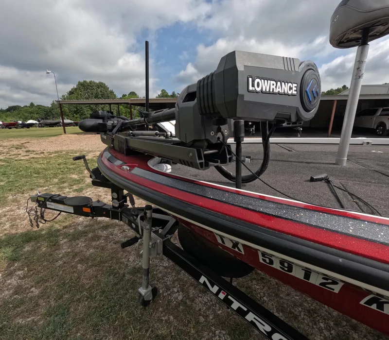 Slide: The Image of 2016 Nitro Z20 boat with Lowrance equipment on a trailer, parked outdoors. - 6