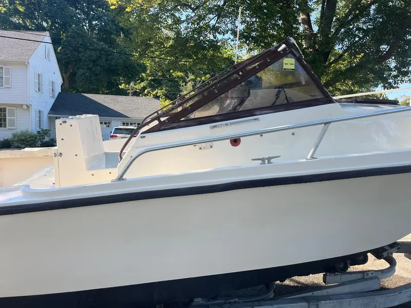 Slide: The Image of 1989 Mako 210 WA boat on trailer, parked in residential area. - 11