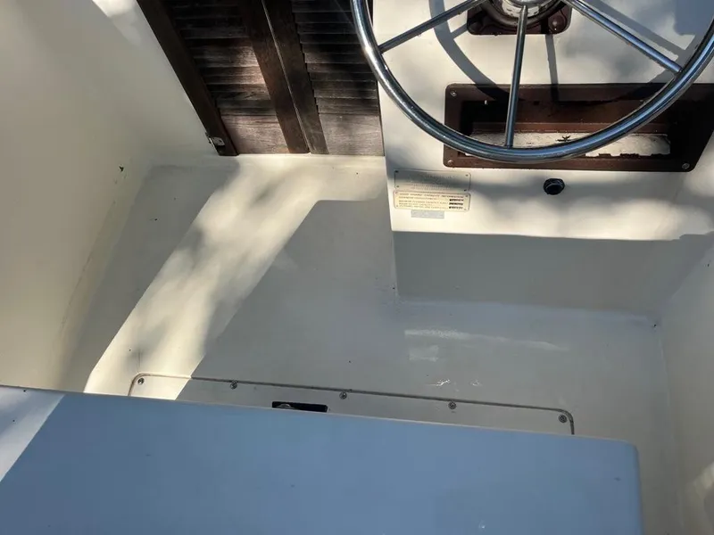 Slide: The Image of Interior of a 1989 Mako 210 WA boat showing steering wheel and deck area. - 19