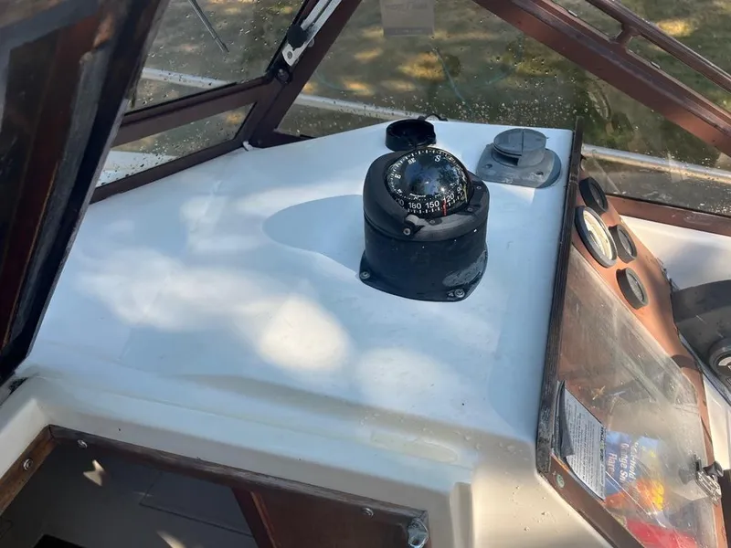 Slide: The Image of 1989 Mako 210 WA boat dashboard with compass and gauges. - 29