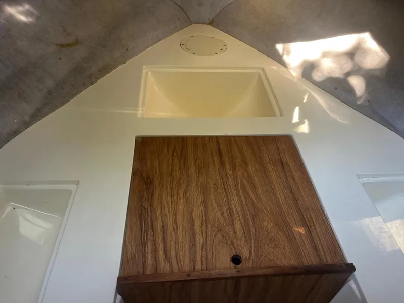 Slide: The Image of Interior view of a 1989 Mako 210 WA boat cabin with wood paneling. - 34