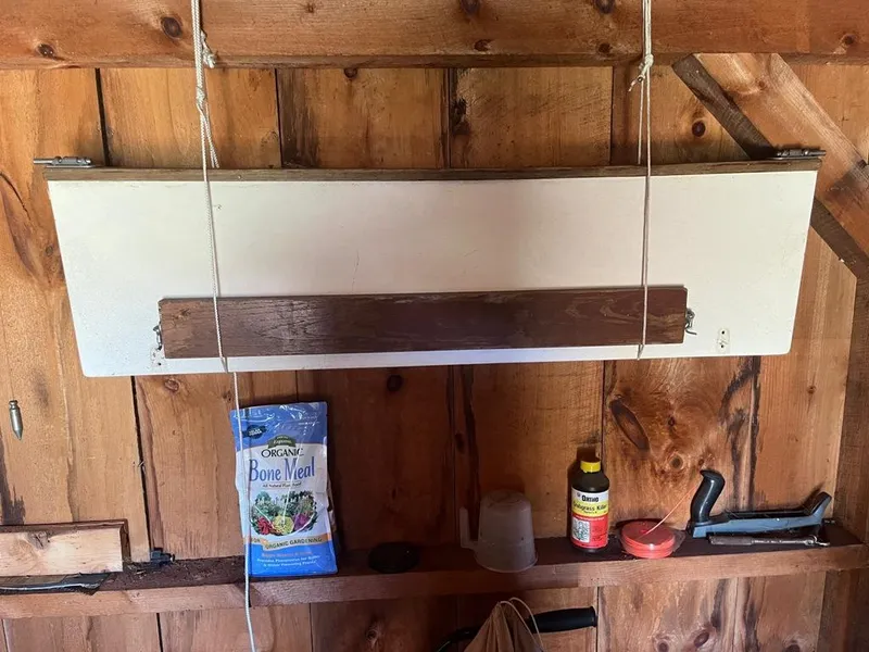 Slide: The Image of Wooden shed interior with gardening supplies and tools on a shelf. - 37