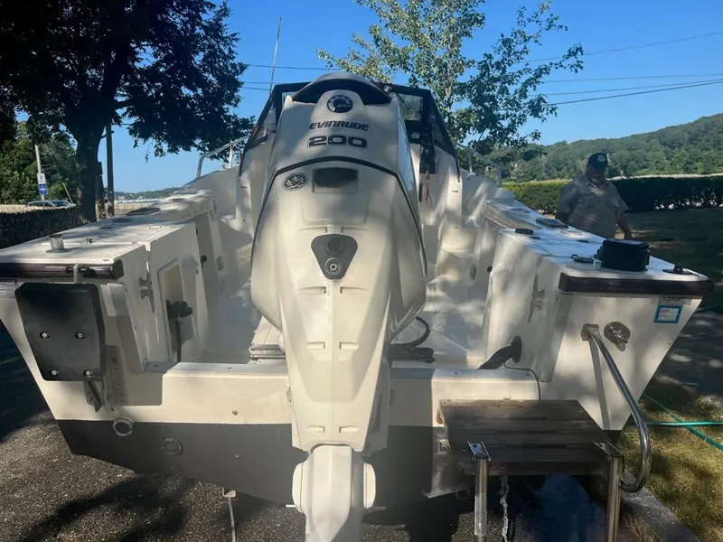 Slide: The Image of 1989 Mako 210 WA boat with Evinrude 200 engine, parked outdoors. - 7