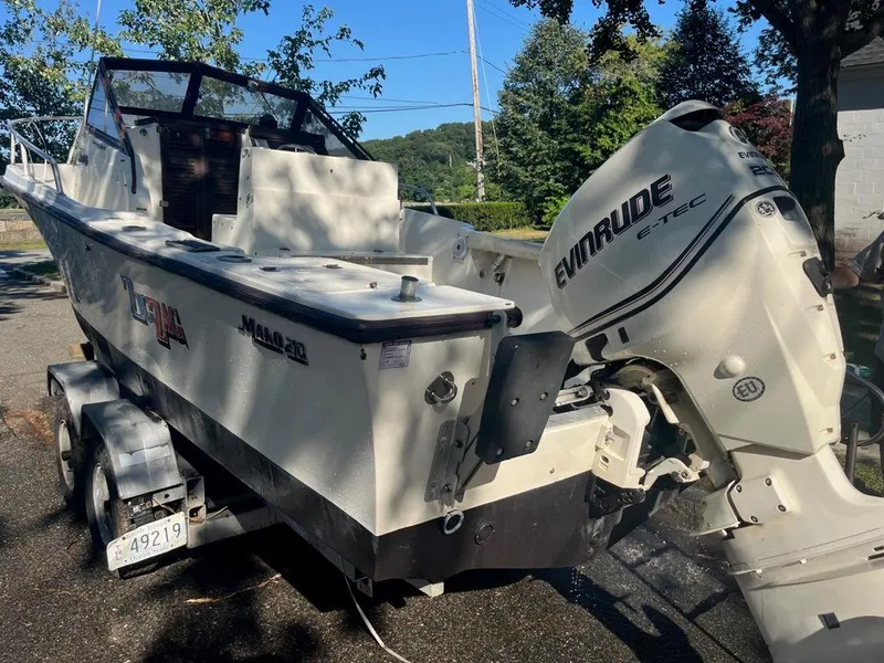 Slide: The Image of 1989 Mako 210 WA boat with Evinrude E-TEC engine on a trailer. - 8