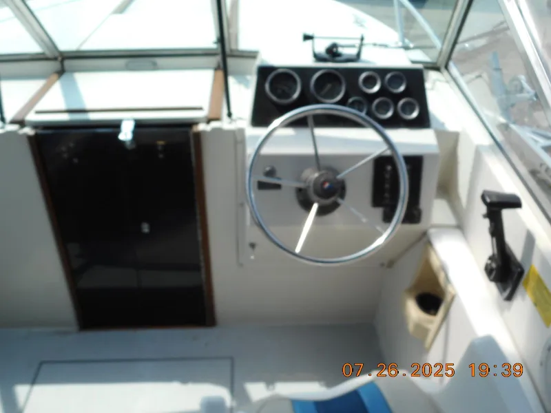 Slide: The Image of 1988 Wellcraft V20 Steplift boat dashboard with steering wheel and gauges. - 3