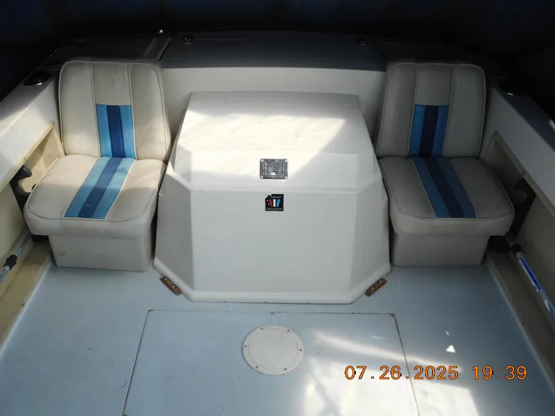 Slide: The Image of 1988 Wellcraft V20 Steplift boat interior with two cushioned seats and central storage. - 5