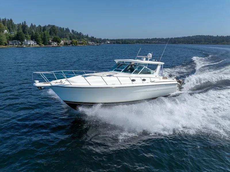 Slide: The Image of 2001 Tiara Sport 4000 EXPRESS cruising on a scenic lake. - 1