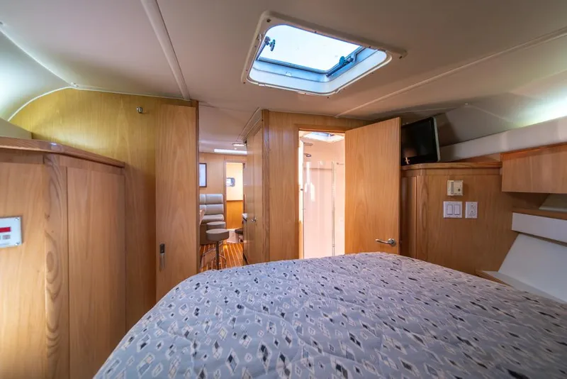 Slide: The Image of Interior cabin of 2001 Tiara Sport 4000 EXPRESS yacht, featuring wood paneling and a skylight. - 18