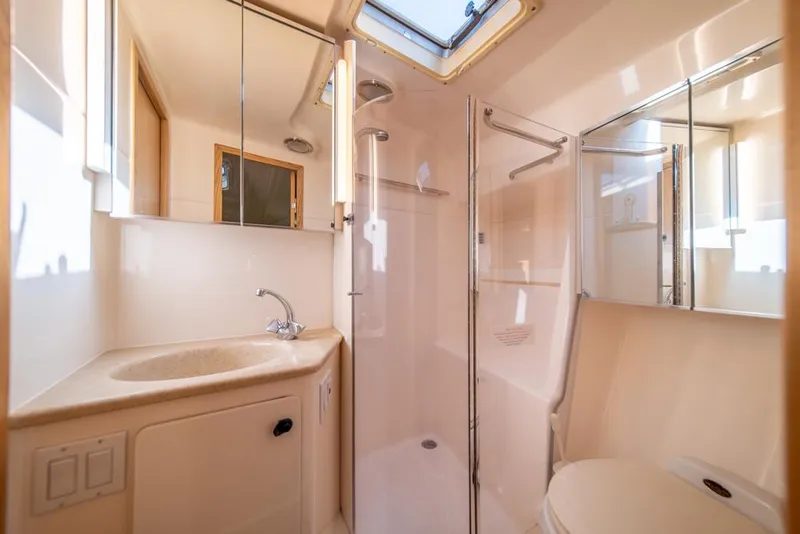 Slide: The Image of Luxurious bathroom in 2001 Tiara Sport 4000 EXPRESS yacht, featuring shower and vanity. - 19