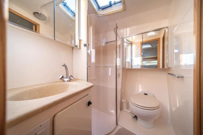 Slide: The Image of Luxurious bathroom in 2001 Tiara Sport 4000 EXPRESS yacht, featuring modern fixtures and skylight. - 20