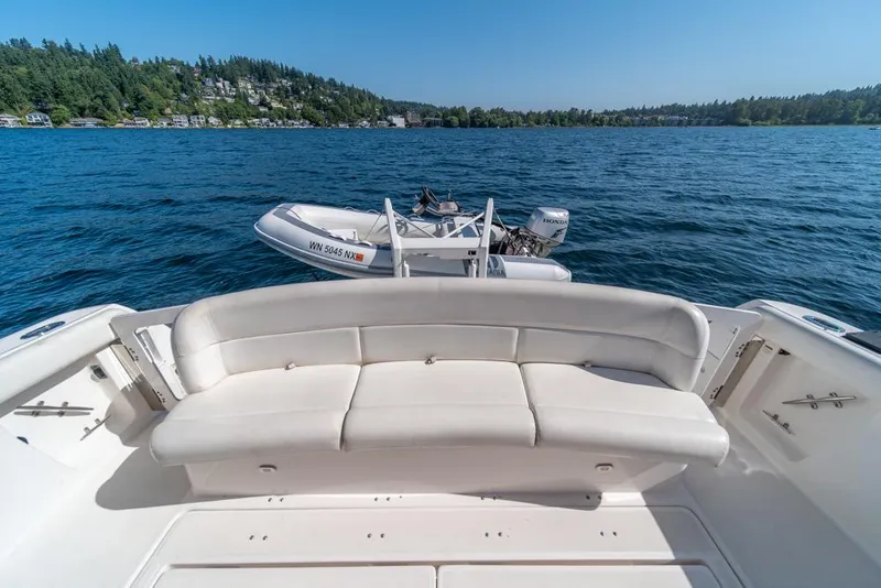 Slide: The Image of 2001 Tiara Sport 4000 EXPRESS yacht with white seating, docked on a serene lake. - 26