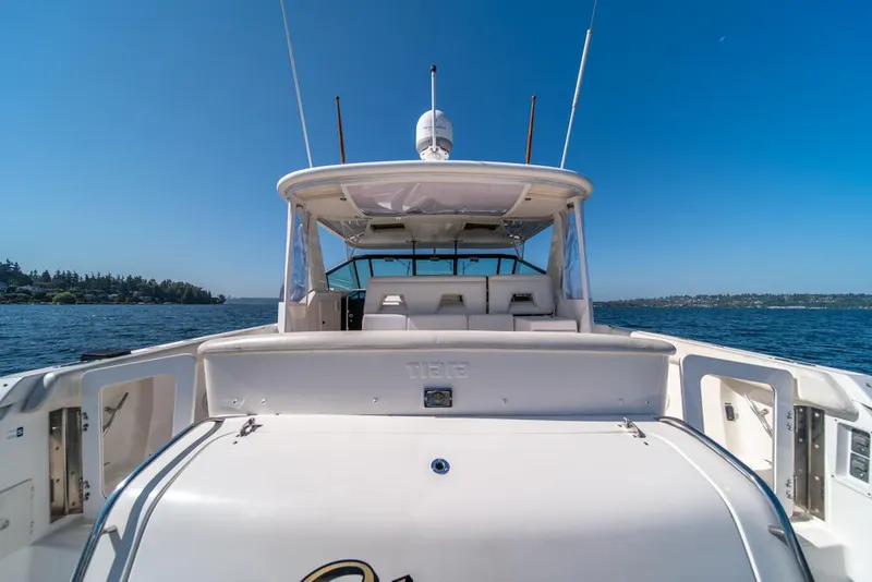 Slide: The Image of 2001 Tiara Sport 4000 EXPRESS yacht on open water under clear blue sky. - 29