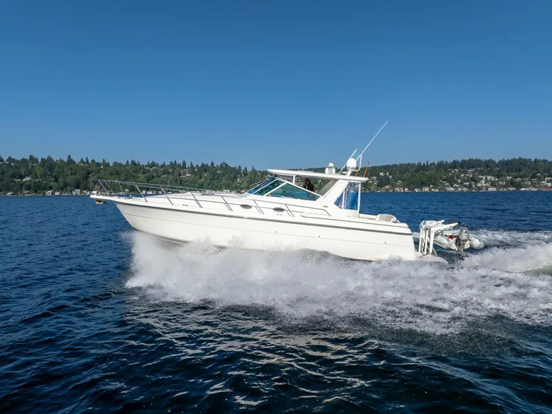 Slide: The Image of 2001 Tiara Sport 4000 EXPRESS cruising on a lake under clear blue skies. - 3