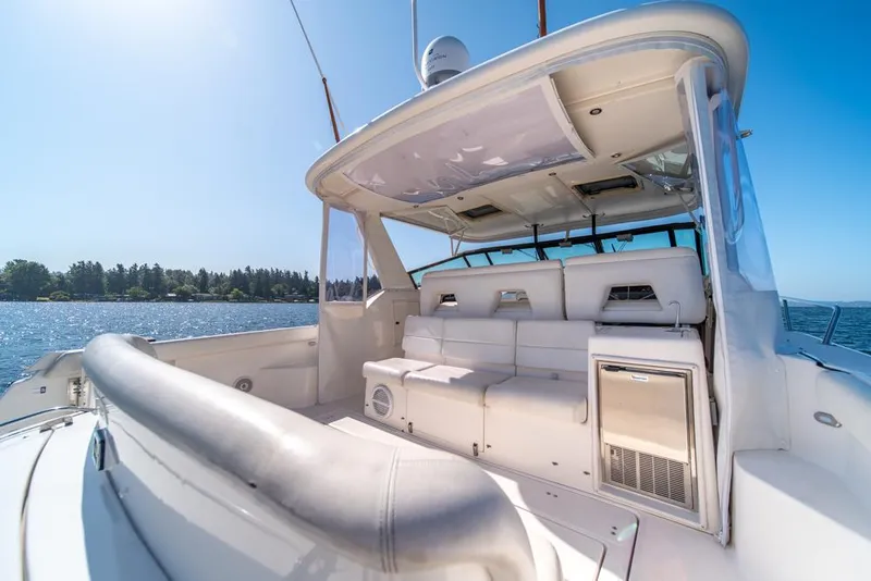 Slide: The Image of 2001 Tiara Sport 4000 EXPRESS yacht interior with seating, on a sunny day by the water. - 30