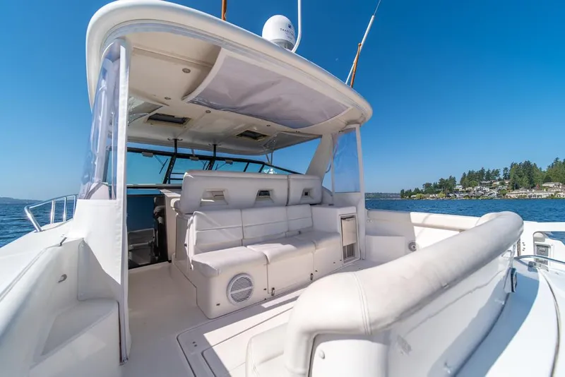 Slide: The Image of 2001 Tiara Sport 4000 EXPRESS yacht interior with white seating, on a sunny day at sea. - 31
