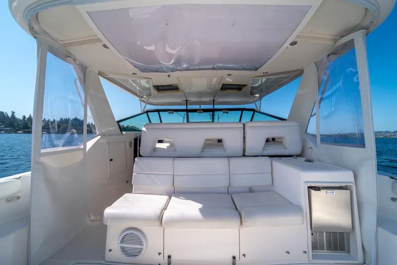Slide: The Image of 2001 Tiara Sport 4000 EXPRESS yacht interior with white seating and open water view. - 32