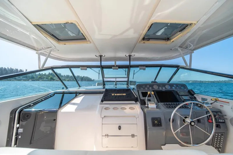 Slide: The Image of 2001 Tiara Sport 4000 EXPRESS yacht cockpit with steering wheel, dashboard, and ocean view. - 35