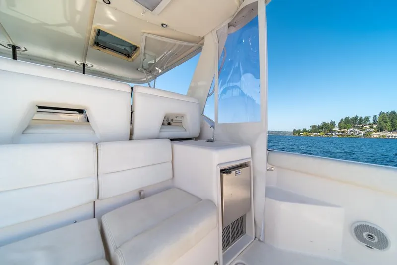 Slide: The Image of Interior of 2001 Tiara Sport 4000 EXPRESS yacht with white seating and scenic water view. - 36