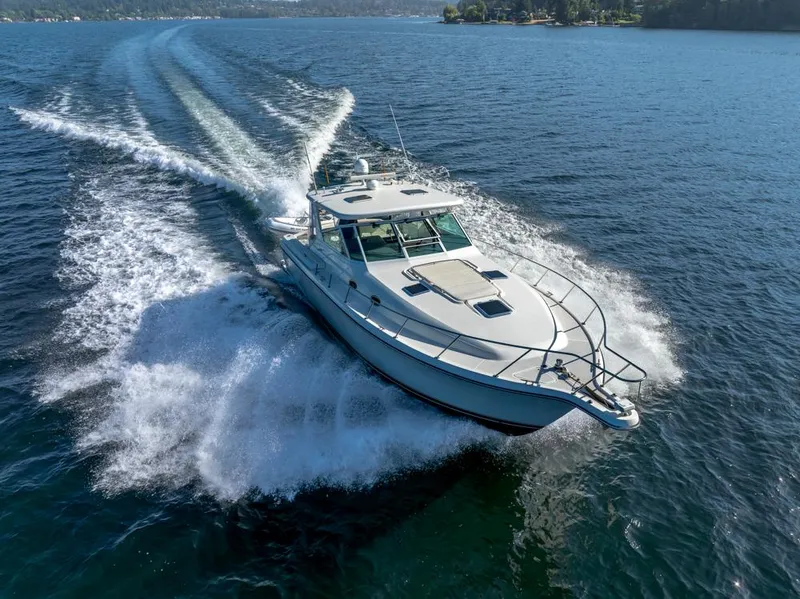 Slide: The Image of 2001 Tiara Sport 4000 EXPRESS cruising on open water, creating a dynamic wake. - 4