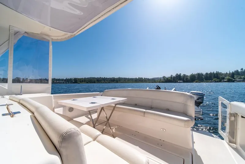 Slide: The Image of 2001 Tiara Sport 4000 EXPRESS yacht with spacious seating, overlooking serene lake and forest. - 41