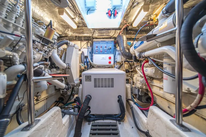 Slide: The Image of Engine room of 2001 Tiara Sport 4000 EXPRESS, showcasing machinery and control panel. - 44