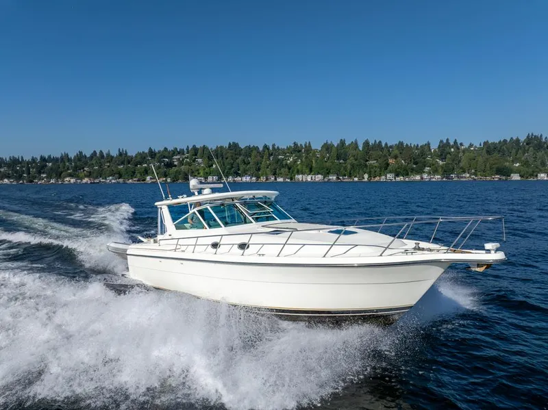 Slide: The Image of 2001 Tiara Sport 4000 EXPRESS cruising on a lake under clear blue skies. - 48