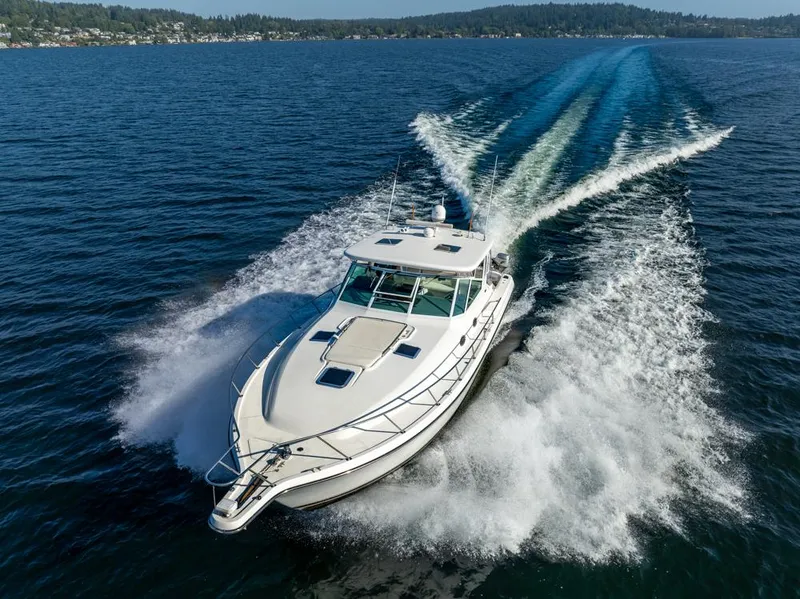 Slide: The Image of 2001 Tiara Sport 4000 EXPRESS cruising on open water, creating a dynamic wake. - 5