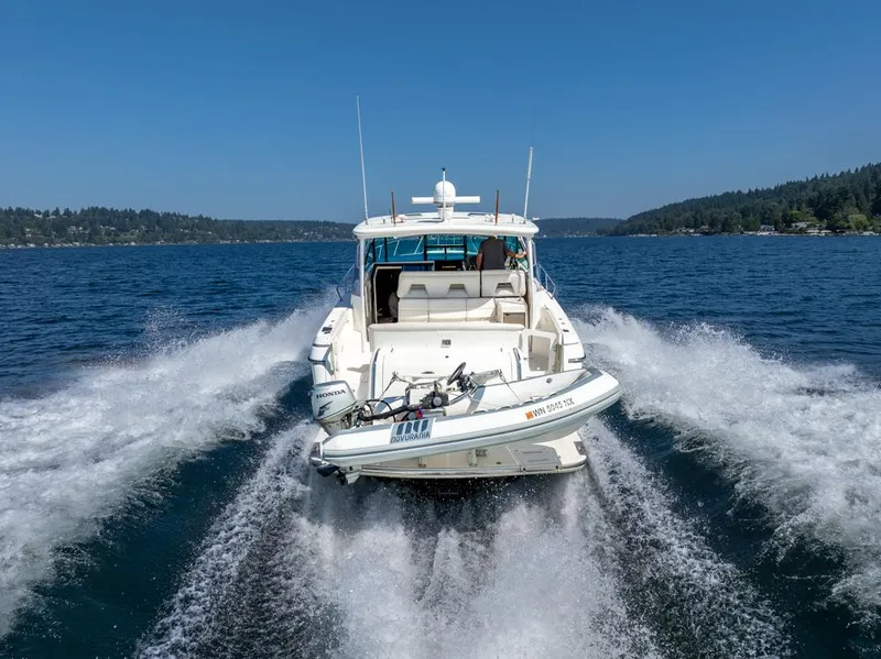 Slide: The Image of 2001 Tiara Sport 4000 EXPRESS cruising on a clear blue lake. - 6