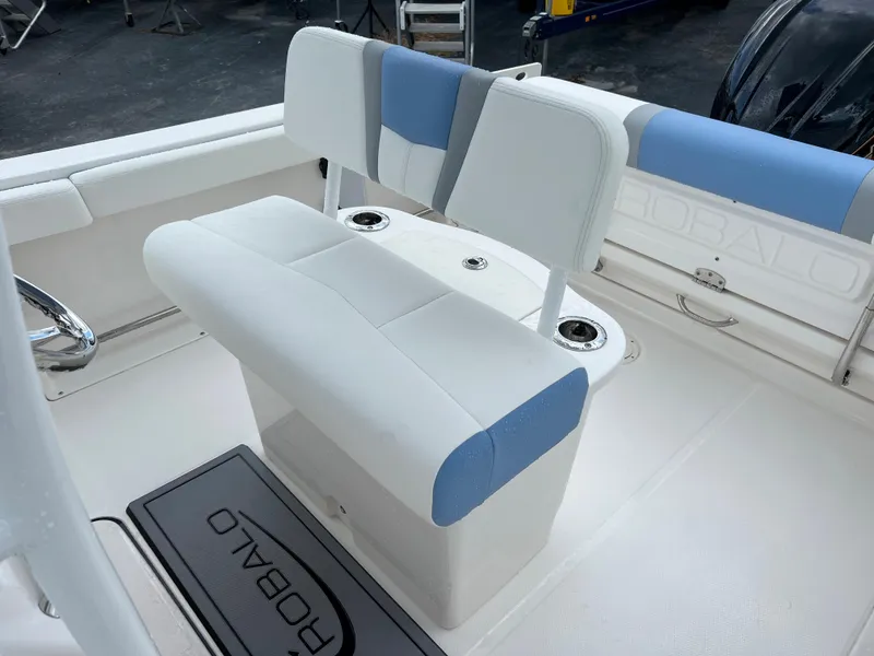 Slide: The Image of 2023 Robalo R222 Center Console boat interior with white and blue seating. - 10