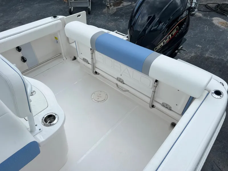 Slide: The Image of 2023 Robalo R222 Center Console boat interior with seating and motor. - 11