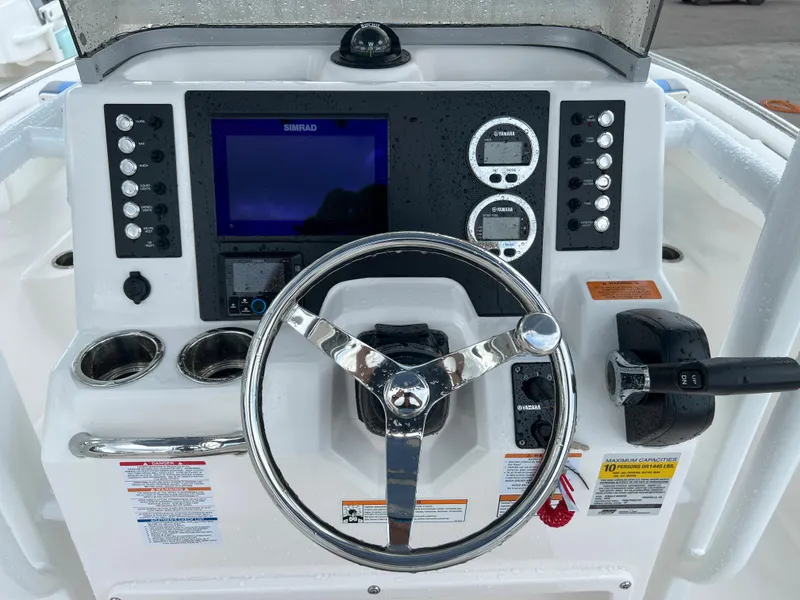 Slide: The Image of 2023 Robalo R222 Center Console dashboard with steering wheel and control panel. - 7