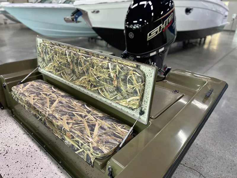 Slide: The Image of 2026 Mi Tide 1602 CC boat with camouflage seating and powerful outboard motor. - 3
