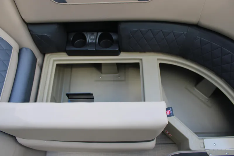 Slide: The Image of Interior of 2026 Starcraft CX 23 RL boat with cup holders and storage compartment. - 13