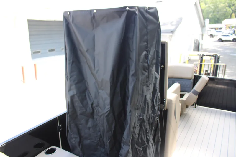 Slide: The Image of 2026 Starcraft CX 23 RL boat interior with black privacy curtain and seating. - 15