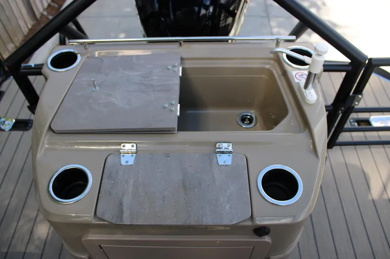 Slide: The Image of 2026 Starcraft CX 23 RL boat sink with cup holders and storage compartments. - 16