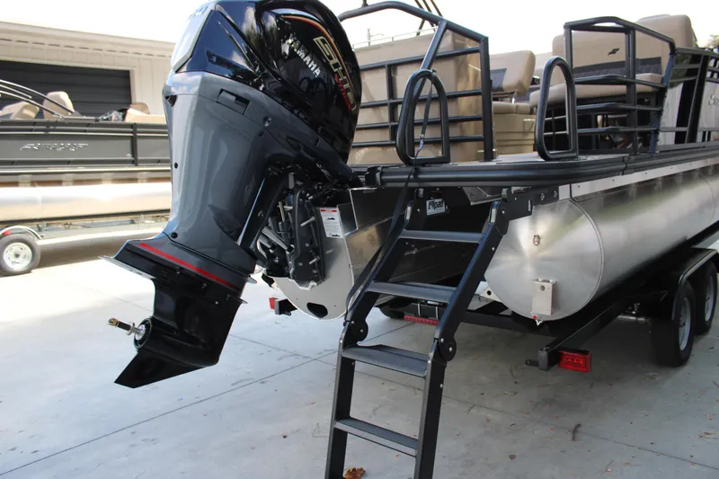 Slide: The Image of 2026 Starcraft CX 23 RL pontoon boat with Yamaha outboard motor and boarding ladder. - 6