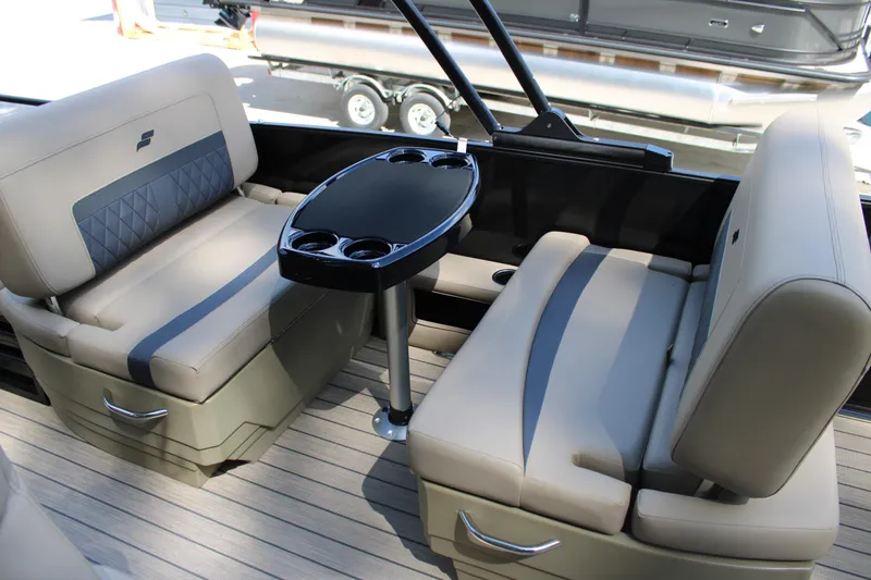 Slide: The Image of Luxurious seating area on 2026 Starcraft CX 23 RL boat with sleek table and cup holders. - 9