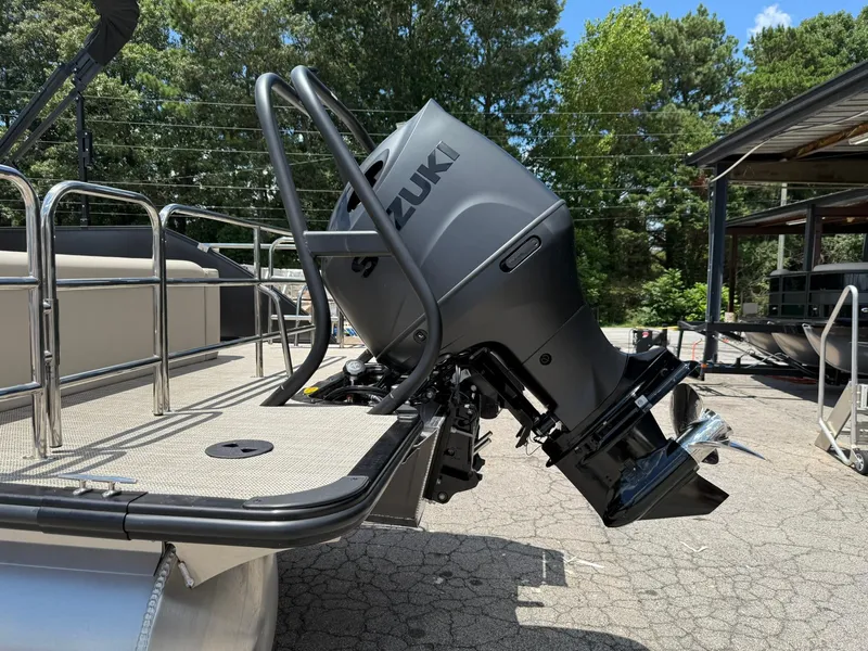 Slide: The Image of 2026 Bentley Pontoons Legacy 243 Swingback with Suzuki outboard motor, docked outdoors. - 16