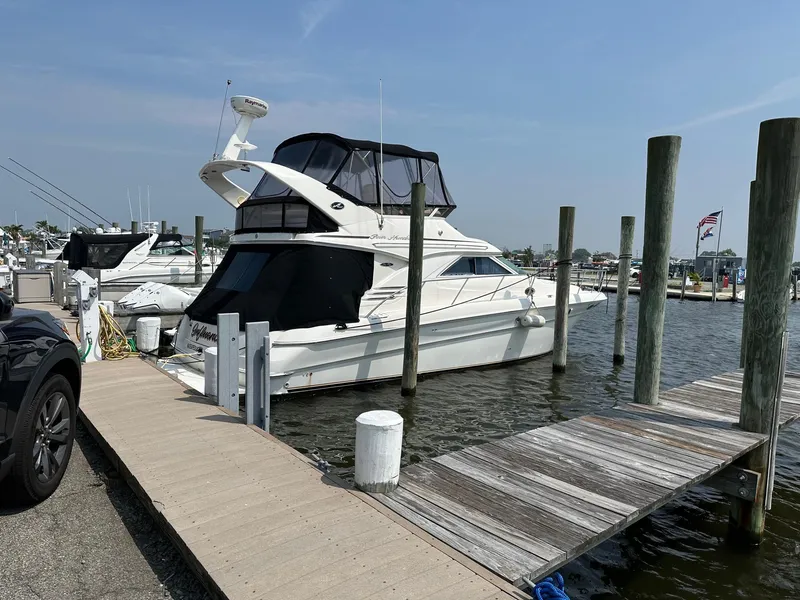 The Image of 2002 Sea Ray 400 Sedan Bridge yacht docked at marina on a sunny day. - 0