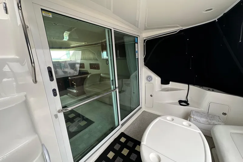 Slide: The Image of Interior view of 2002 Sea Ray 400 Sedan Bridge yacht with sliding glass door. - 12