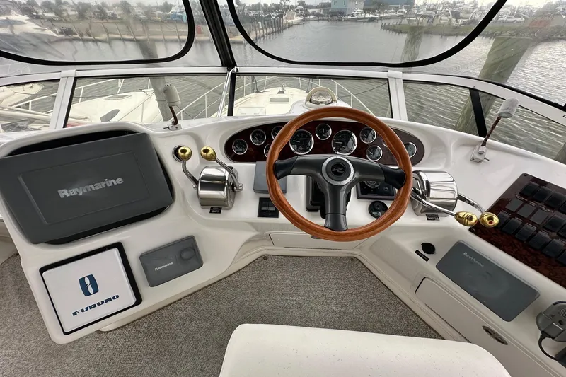 Slide: The Image of Cockpit of 2002 Sea Ray 400 Sedan Bridge with steering wheel and navigation equipment. - 15