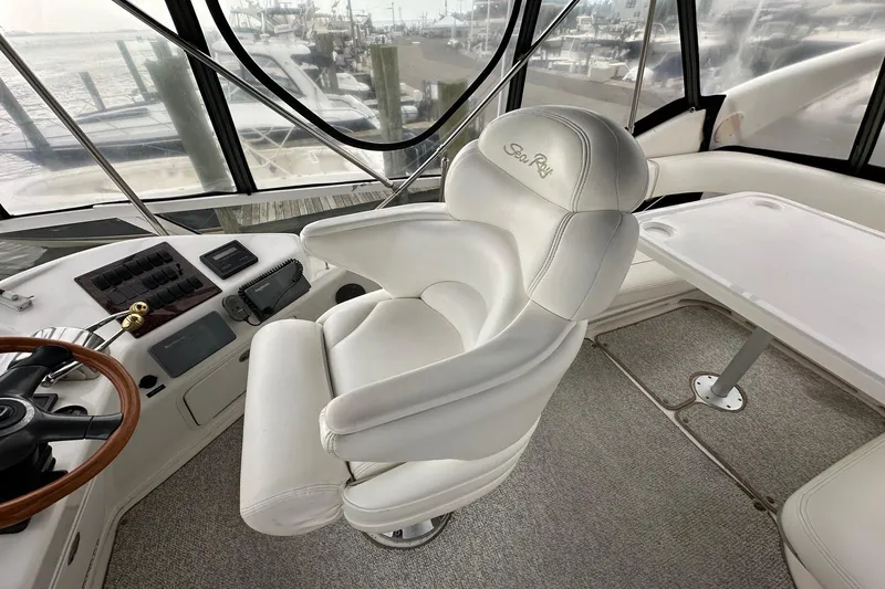 Slide: The Image of Interior of 2002 Sea Ray 400 Sedan Bridge, featuring helm and white captain's chair. - 19